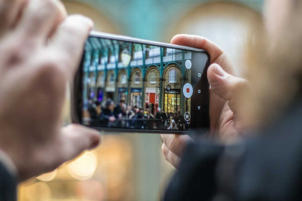 Hands holding a phone recording video